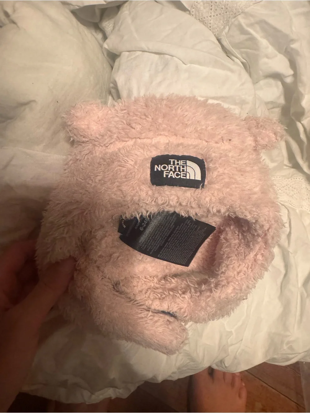 North Face Baby Bear Suave Oso Beanie in pink with a prominently displayed woven